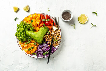Trendy vegetarian, vegan salad with avocado, tomato, red cabbage, chickpea, fresh lettuce salad, pumpkin, persimmon. banner, catering menu recipe place for text, top view