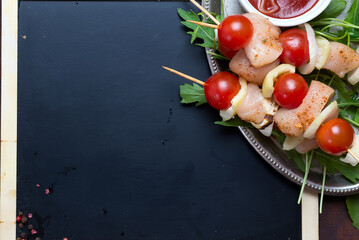 BBQ barbecue ingredients with marinated BBQ grill chicken and sherry tomato with chalk board for copy space