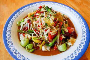 Thai food top view , papaya salad spicy with yardlong bean herbs and spices ingredients chilli tomato peanut garlic served on table.