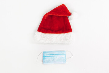 Santa Claus hat with medical protective mask, on an isolated white background