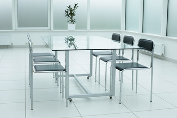 Black chairs glass table in office space