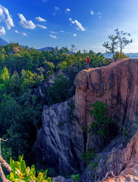 Male tourists stand on the viewpoint of Pai Canyon in Pai District, Mae Hong Son Province, Thailand.