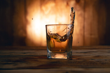 Whiskey glass on a wooden table.