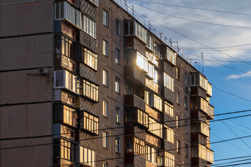 Urban architecture, the windows of the building shine with the rays of the sun.