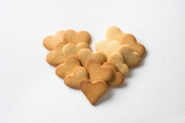 Homemade heart shaped cookies on white table. Valentines day greeting card. Love concept. View from above.
