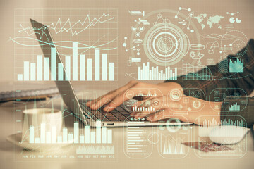 Double exposure of businesswoman hands typing on computer and forex graph hologram drawing....