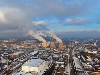 Aerial view smoke from pipes of a large industrial enterprise. Pollution of the ecology of the big city. Thermal energy generation.