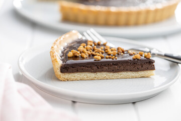 Sweet chocolate pie with crushed nuts.