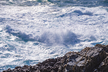 日本海の荒波と柱状節理の岩礁　島根県出雲市大社町　The raging waves of the Sea of Japan and column pillar   rocks