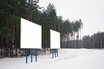 a white Billboard is located by the road