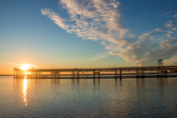 Fototapeta premium Sunset at Mining pier known as the Tinto Dock at sunset 