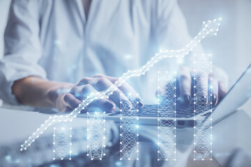 Double exposure of woman hands typing on computer and forex chart hologram drawing. Stock market...