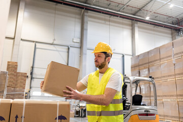 Warehouse worker taking package for delivery to customer