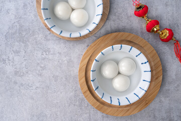 Top view of big tangyuan yuanxiao in a bowl on gray background for lunar new year food.