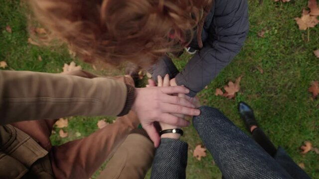 Family members piling up their hands, parents playing with child, connection