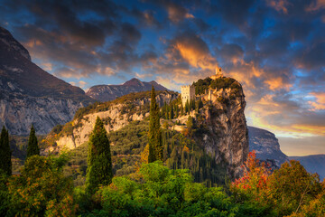 Obraz premium Amazing ruins of Arco Castle on the cliff in northern Italy at sunset.