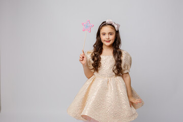 little girl in the image of a fairy with a magic wand on a white background