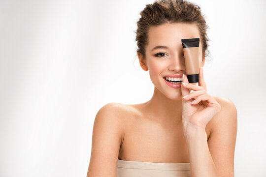 Woman with liquid foundation. Photo of woman with perfect makeup on white background. Beauty concept
