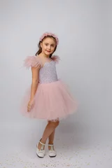 Fotobehang little girl in a beautiful dress prinses on a white background © Olesya Pogosskaya