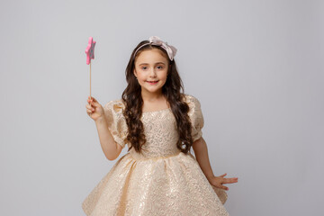 little girl in the image of a fairy with a magic wand on a white background