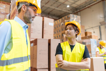 Warehouse workers consult delivery plans