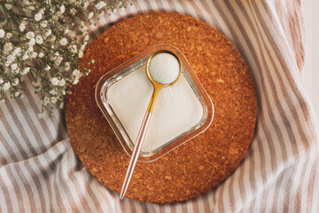 Collagen powder and measure spoon. Extra protein intake concept. Beauty supplement and vitamins for health concept. Trendy product for skin, joints and bones.