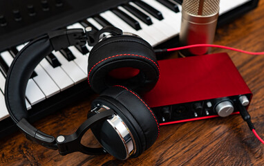 Piano, headphones, microphone and sound card. Recording studio.