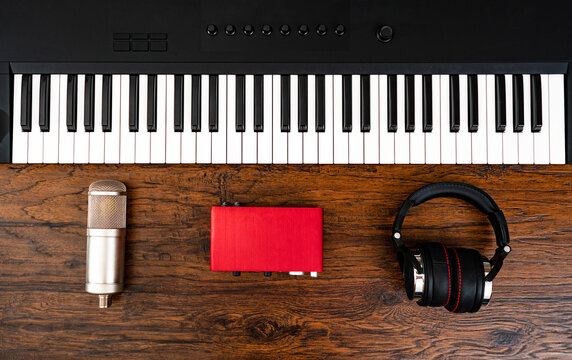 Piano, headphones, microphone and sound card. Recording studio.