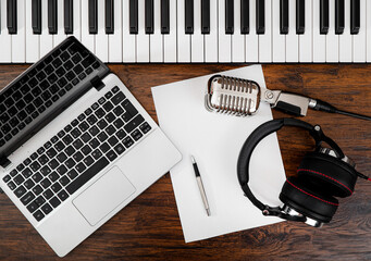 Music studio equipment and white paper with pen. Songwriting concept.
