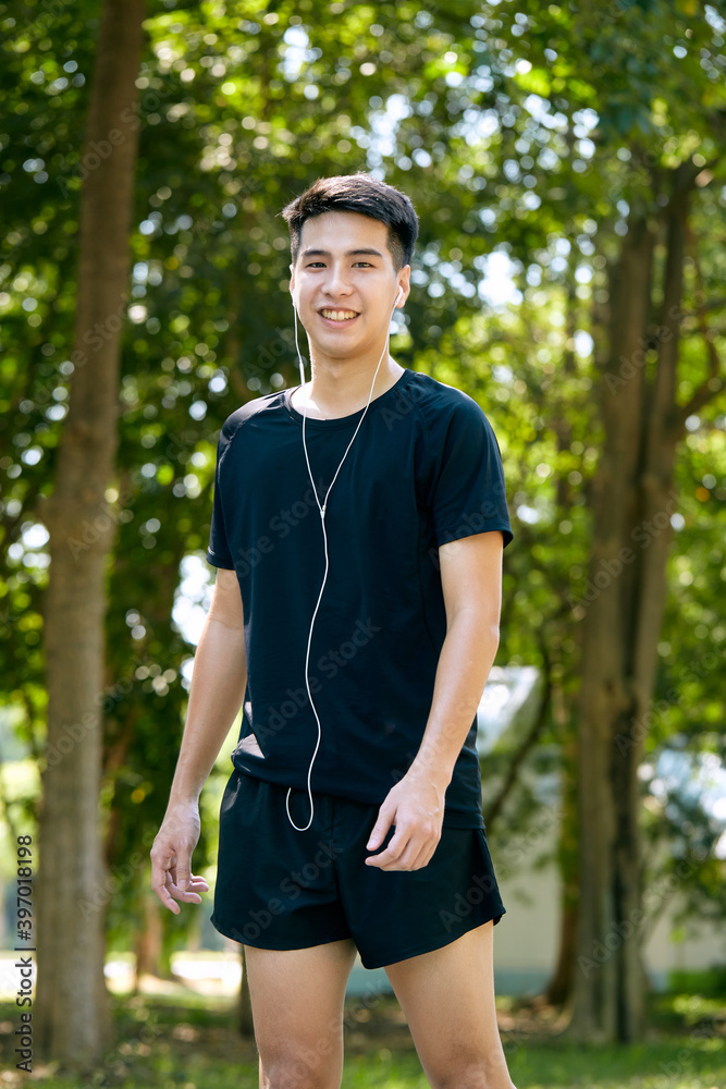 Wall mural Young Man Jogging in the park