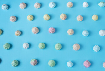 Meringue pattern on blue background. Top view