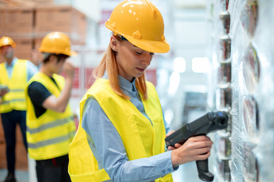 Workers in warehouse scanning packages