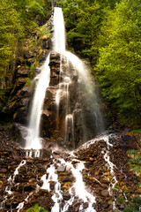 Beautiful waterfall in the forest. Germany Black Forest. Long quote exposure and trees. Cliff river
