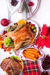 Table served for thanksgiving or Christmas dinner. Stuffed roasted turkey and glazed ham. Traditional celebrating holiday.