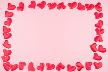 Valentines day background with red hearts, on a pink background, top view, place for text