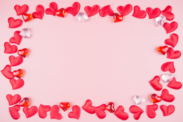 Valentines day background with red hearts, on a pink background, top view, place for text