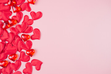 Valentines day background with red hearts, on a pink background, top view, place for text