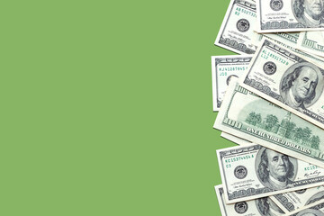 American 100 dollar bills on a light green colored background. Cash, currency. Copy space, top view, banner. Business, finance concept. Savings