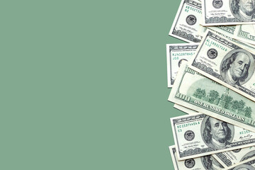 American 100 dollar bills on a light green colored background. Cash, currency. Copy space, top view, banner. Business, finance concept. Savings