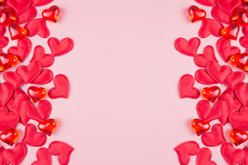 Valentines day background with red hearts, on a pink background, top view, place for text