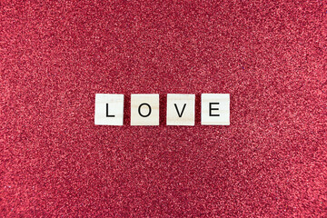 Fototapeta na wymiar Word Love, on a red background. Valentines day background