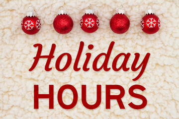 Obraz na płótnie Canvas Holiday Hours message with Christmas red balls