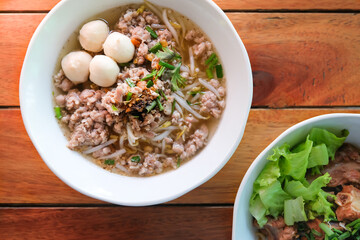 Top view of pork noodles clear soup, braised pork spare ribs noodles without soup on the wooden table.