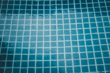 Blue tiles swimming pool water reflection texture