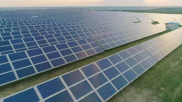 Aerial view of large number of solar power cells on energy station standing in row. Concept of future technology,renewable sun and alternative energy.