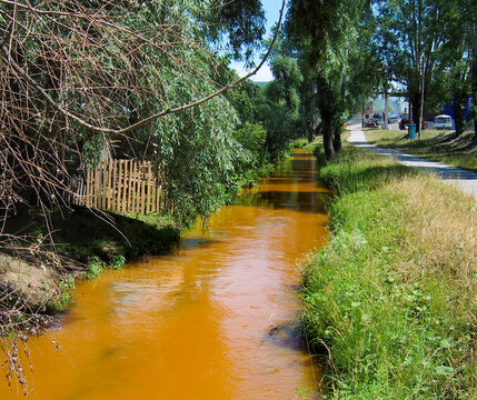 The Teplushka river with orange discharges in the city of Asha. The summer of 2010