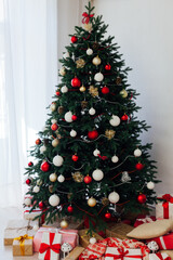 beautiful Christmas tree interior with new year decor gifts