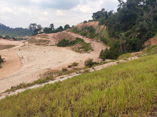 IPOH, MALAYSIA - MARCH 16, 2020: Permanent slope protection using the close turfing method to prevent erosion. The selected type of grass used for the method. The grass also stabilizes the slope 