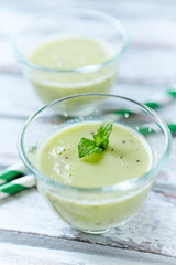 Green smoothie topped with chia seeds on bright wooden background. Close up.	