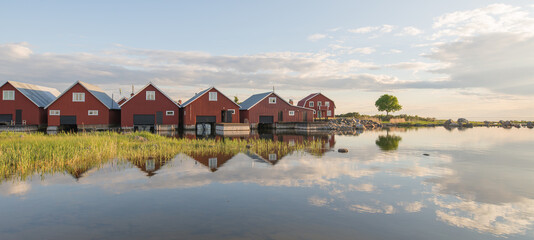 Naklejka na ściany i meble Beautiful fisherman typical red cabins on the Swedish east coast 